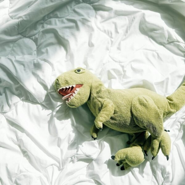 Green plush dinosaur dog toy